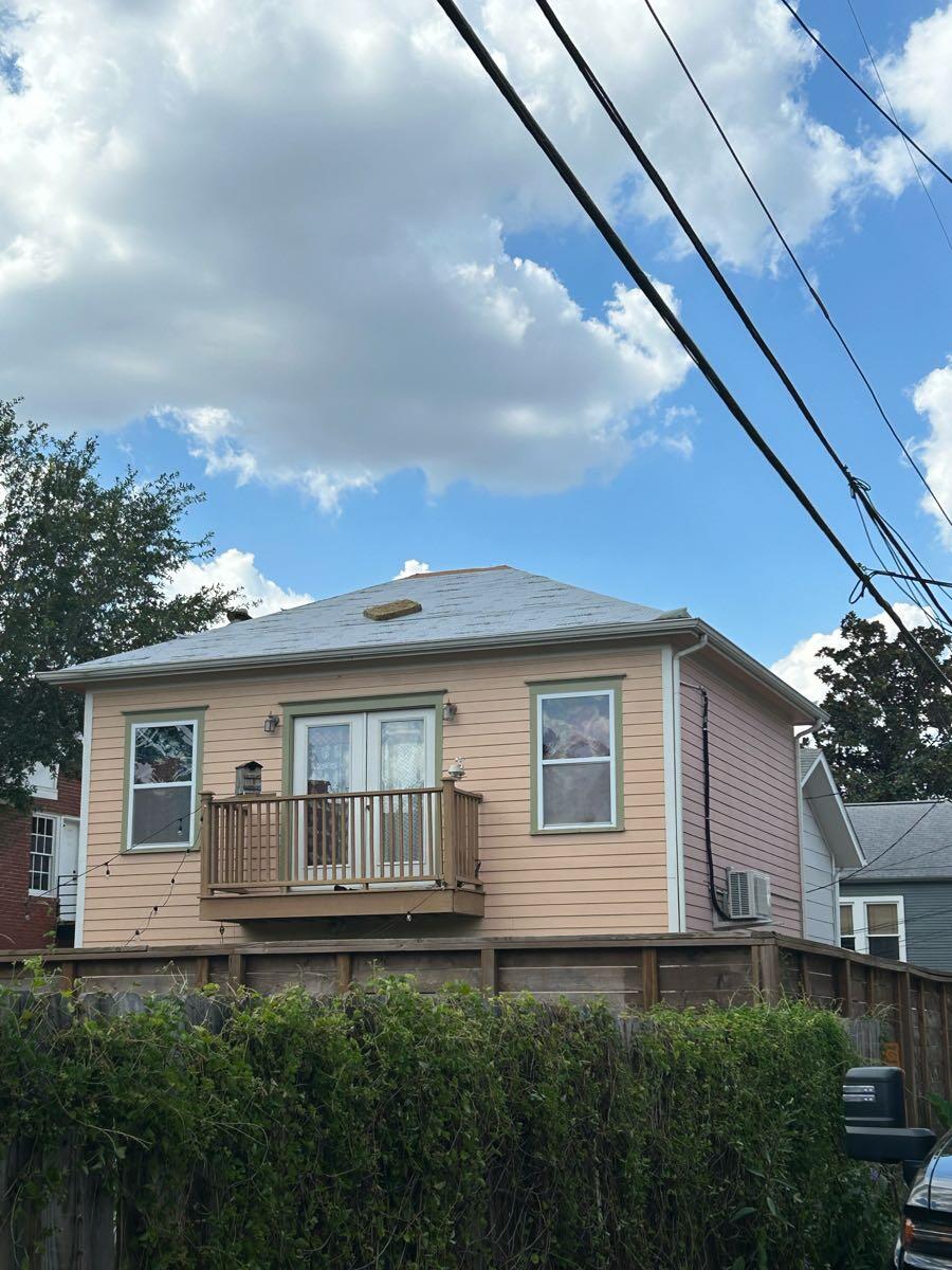 Rear view of a Heights garage apartment during roof replacement